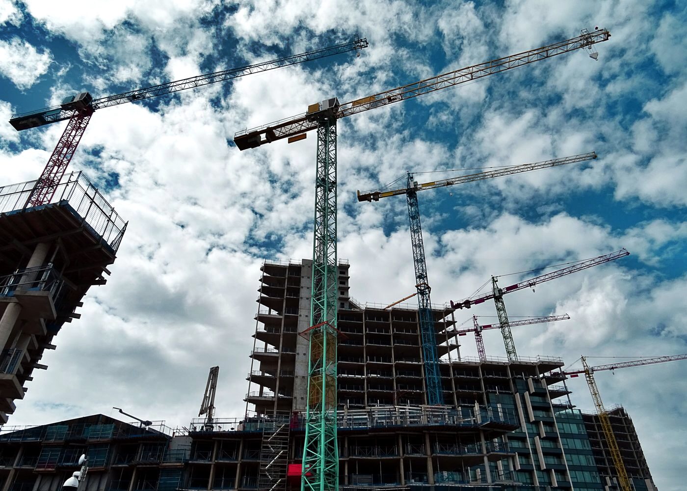 Tower cranes over a high-rise under construction